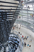 Germany, Berlin, Mitte, Tiergarten, interior of the glass dome on the top of the Reichstag building designed by architect Norman Foster with a double-helix spiral ramp around the mirrored cone that re...