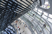 Germany, Berlin, Mitte, Tiergarten, interior of the glass dome on the top of the Reichstag building designed by architect Norman Foster with a double-helix spiral ramp around the mirrored cone that re...