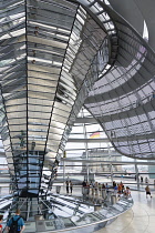 Germany, Berlin, Mitte, Tiergarten, interior of the glass dome on the top of the Reichstag building designed by architect Norman Foster with a double-helix spiral ramp around the mirrored cone that re...