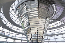 Germany, Berlin, Mitte, Tiergarten, interior of the glass dome on the top of the Reichstag building designed by architect Norman Foster with a double-helix spiral ramp around the mirrored cone that re...