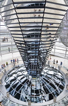 Germany, Berlin, Mitte, Tiergarten, interior of the glass dome on the top of the Reichstag building designed by architect Norman Foster with a double-helix spiral ramp around the mirrored cone that re...