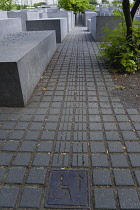 Germany, Berlin, Mitte, wheelchair access to the Holocaust Memorial designed by US architect Peter Eisenmann with a field of grey slabs symbolizing the millions of Jews killed by the Nazis.