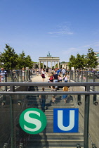 Germany, Berlin, Mitte, sightseeing tourists emerging from the U-Bahn and S-Bahn station on Unter den Linden and walking towards Brandenburg Gate or Bransenburger Tor.