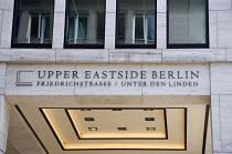 Germany, Berlin, Mitte, New York influenced sign reading Upper Eastside Berlin on redeveloped area at the junction of Friedrichstrasse and Unter den Linden