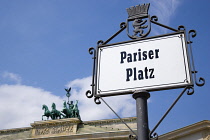 Germany, Berlin, Mitte, Brandenburg Gate or Bransenburger Tor in Pariser Platz with sign leading to Unter den Linden and the Royal Palaces with the Quadriga of Victory on top. The only remaining of th...