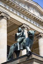 Germany, Berlin, Mitte, The Konzerthaus Concert Hall, home of the Berlin Symphony Orchestra, entrance portico with a bronze statue of a muse playing music seated on a panther.