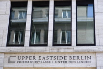 Germany, Berlin, Mitte, New York influenced sign reading Upper Eastside Berlin on redeveloped area at the junction of Friedrichstrasse and Unter den Linden