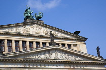 Germany, Berlin, Mitte, The Konzerthaus Concert Hall, home of the Berlin Symphony Orchestra, with a bronze statue of Apollo, God of the Arts, in a chariot drawn by two griffins.