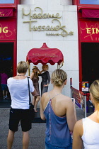 Germany, Berlin, Mitte, outside Madame Tussauds on Unter den Linden tourists have their photograpgh taken beside a statue of Marilyn Monroe.