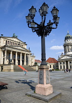 Germany, Berlin, Mitte, The Gendarmenmarkt square with an ornate lamp-post between the Konzerthaus Concert Hall, home to the Berlin Symphony Orchestra, and The French Cathedral, Franzosischer Dom.