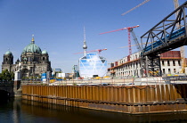 Germany, Berlin, Mitte, Museum Island with copper domed Berliner Dom, Berlin Cathedral, and tower cranes on construction sites beside the Spree River and the distant the Fernsehturm TV Tower.