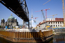 Germany, Berlin, Mitte, Museum Island with copper domed Berliner Dom, Berlin Cathedral, and tower cranes on construction sites beside the Spree River and the distant the Fernsehturm TV Tower.