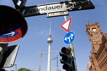 Germany, Berlin, Mitte, The Fernsehturm TV Tower with cranes working on reconstruction of the old eastern sector, roadsigns and traffic lights by the Rotes Rathaus on Spandauer Strasse.