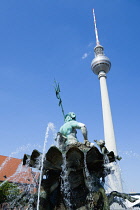 Germany, Berlin, Mitte, The Neptune Fountain or Neptunbrunner by Reinhold Begas dated 1891 beside Marienkirche St Mary's Church with the Fernsehturm TV Tower in Alexanderplatz beyond.