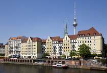 Germany, Berlin, Mitte, buildings beside the River Spree in the St Nicholas Quarter, the Nikolaiviertel, with the twin spired church of St Nicholas, the oldest church in the city and the Fernsehturm T...