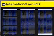 England, London, Heathrow Airport, International Arrivals hall in Terminal 5 with electronic arrivals board listing incoming due flights.