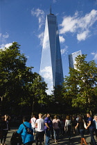 USA, New York, Lower Manhattan, One World Trade Center tower skyscraper, the tallest building in the city, with sightseeing tourists.