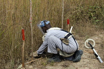 Angola, Mine clearence specialist preparing equipment used to look for unexploded ordenance.