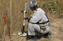 Angola, Mine clearence specialist preparing equipment used to look for unexploded ordenance.