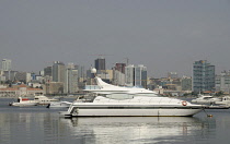 Angola, Luanda, Luxury yacht with downtown in the background.