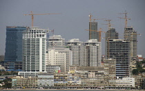 Angola, Luanda, Seafront promenade, with old buildings in foreground and new buildings under construction in background.