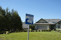 Canada, British Columbia, Vancouver Island, Tsunami warning sign outside a private residence close to Tofino.