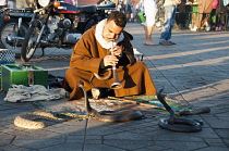 Morocco, Marrakech, Snake charmer in in Djemaa el Fna square.