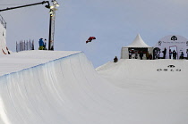 Norway, Oslo, Tryvann Winter Park, Competitor during Arctic Challenge half pipe snow board competition.