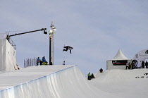 Norway, Oslo, Tryvann Winter Park, Competitor during Arctic Challenge half pipe snow board competition.