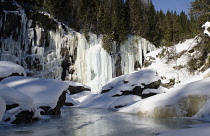 Norway, Golsjuvet, Frozen waterfalls with frozen river in foreground at climbing area close to Gol.