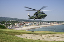 Ireland, County Wicklow, Bray, Irish Air Force helicopter display above Bray seafront.