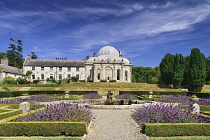 Ireland, County Wicklow, Bray, Kilruddery House and Gardens, View from the west side featuring the domed Orangery building with formal gardens in the foreground.