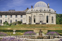 Ireland, County Wicklow, Bray, Kilruddery House and Gardens, View from the west side featuring the domed Orangery building with formal gardens in the foreground.