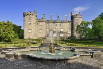 Ireland, County Kilkenny, Kilkenny, Kilkenny Castle with the Rose Garden and fountain in the foreground.