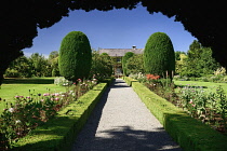 Ireland, County Carlow, Tullow, Altamont Garden and house, pathway leading to the house with roses lining both sides and manicured trees.