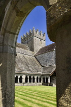 Ireland, County Tipperary, Holycross Abbey, view through an arch of the cloister.