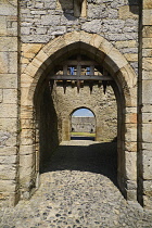 Ireland, County Tipperary, Cahir, Cahir Castle, View through portcullis gate.