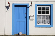 Ireland, County Mayo, Cong, Traditional house facade with cartons of milk outside the door.