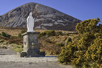 Ireland, County Mayo, Murrisk, The holy pilgrimage mountain of Croagh Patrick with a statue of Saint Patrick in the foreground.