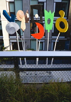 USA, New York, Manhattan, High Line linear park between buildings on a disused elevated railroad spur with people viewing a sculpture by Charlie Hewitt called Urban Rattle the first public art on the...