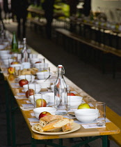 USA, New York, Manhattan, tables laid with bread, fruit and water in readiness for a social soup experiment by Hearth Restaurant in the 14th Street Passage on the High Line linear park on an elevated...