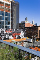 USA, New York, Manhattan, section of the Chelsea Grasslands on the High Line linear park on a disused elevated railroad spur called the West Side with a billboard for the Rubin Museum of Art and a sky...