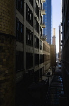 USA, New York, Manhattan, view along a narrow alley between industrial buildings beside the High Line linear park on an elevated disused railroad spur called the West Side Line.