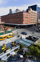 USA, New York, Manhattan, View in Greenwich Village from the High Line linear park onto a road junction with restaurant and shops.