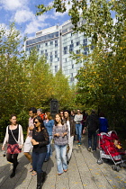 USA, New York, Manhattan, people walking in The Gansevoort Woodland on the High Line a linear park on an elevated disused railroad called the West Side Line.