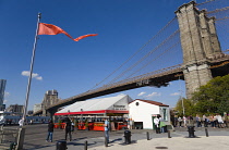 USA, New York, Brooklyn Bridge Park, Fulton Ferry Pier below the suspension bridge spanning the East River.