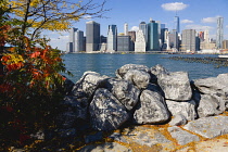 USA, New York, Lower Manhattan skyline skyscrapers and East River seen in autumn from Brooklyn Bridge Park.