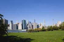 USA, New York, Lower Manhattan skyscraper skyline and East River seen from Brooklyn Bridge Park.