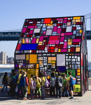 USA, New York, Brooklyn Bridge Park, schoolchildren at the colourful plexiglass house called Kolonihavehus by sculptor Tom Fruin beside the East River.