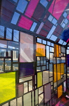 USA, New York, Brookly Bridge Park, colourful plexiglass house called Kolonihavehus by sculptor Tom Fruin below the bridge spanning the East River with Lower Manhattan beyond.